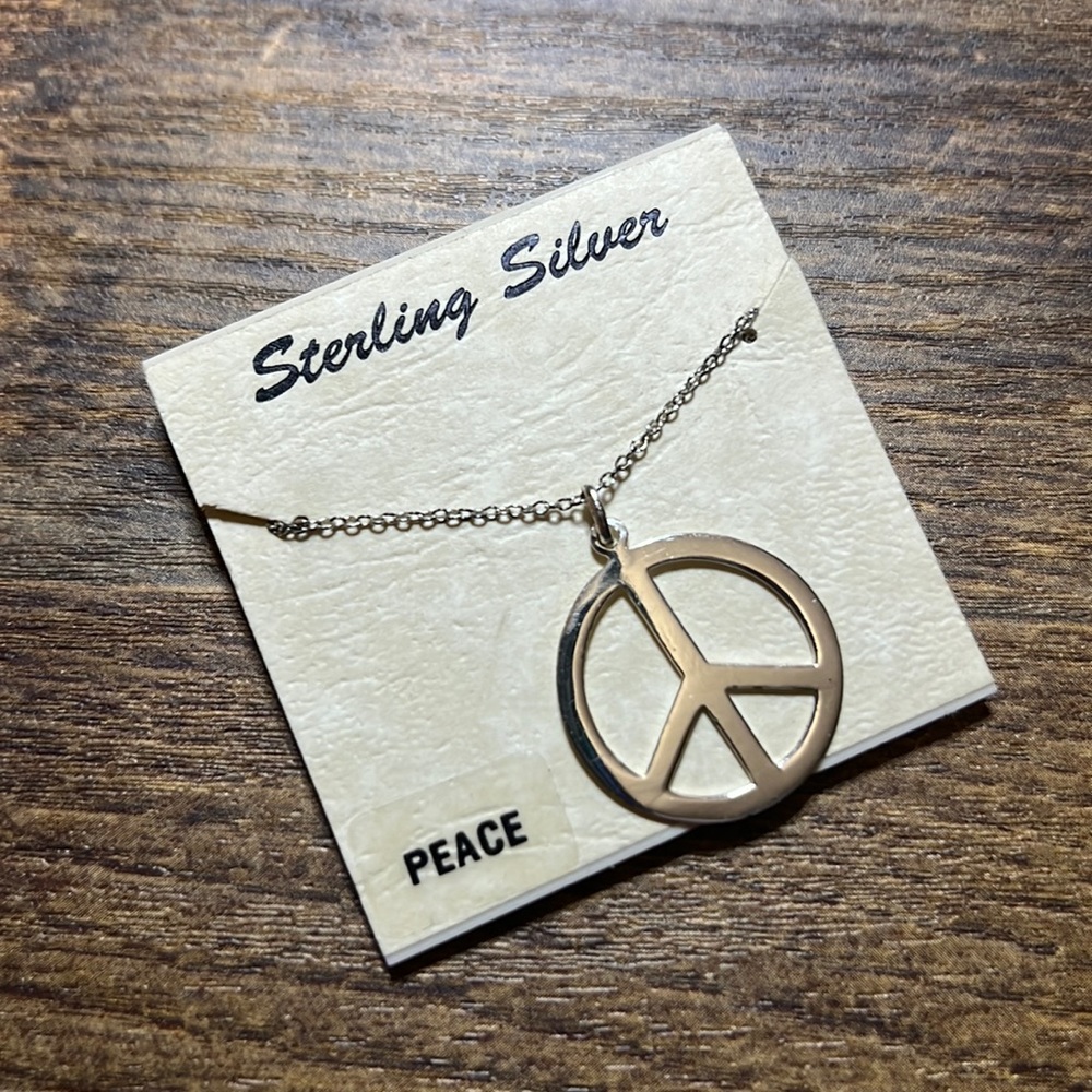 Never worn sterling silver peace sign necklace